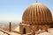 View of the large dome of Zinciriye Medresesi and the minaret of Mardin Grand Mosque in Turkey