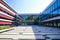 View on large inner courtyard of modern town hall with reflecting glass facade and red awnings