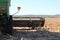 view of large scale farming harvesting equipment in an already harvested field in rural New South Wales, Australia