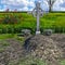 View of a large, well-groomed grave in a cemetery with plants