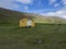 View on latrar camp site in adalvik cove with yellow emergency shelter cabin in west fjords Hornstrandir in Iceland