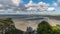 View from Le Mont Saint Michelle over the sea at low tide on a cloudy day