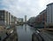 a view of leeds dock from the lock gates showing waterside developments offices and apartment buildings with houseboats moored in