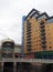 View of leeds with the river aire entering the dark arches under the railway station with pedestrian footbridge and office and