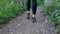 View on Legs of Traveler Woman Hiking on the Forest Trail Path in Mountain