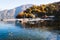 View of Lenno town. Yacht bay at lake and mountains. Como Lake