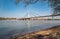 View of Liberty bridge in Novi Sad, Serbia with Danube river and city beach Strand in the early springtime with blue water and sky