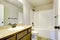 View of light tones bathroom with modern vanity cabinet.