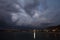 View of lightning strike over a rural farm field, lightning strikes the ground, strong thunder, lightning, dark clouds in the sky