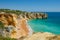 View of limestone cliffs and the Rabbit Beach Praia da Coelha in Albufeira, District Faro, Algarve, Southern Portugal