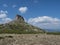 View of limestone tower Perda Liana, impressive rock formation on green forest hill, sardinian table mountain. National