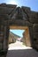 View through the Lion Gate on a stone path and tourists in the a