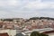 View of the Lisbon from the viewpoint Miradouro de Sao Pedro de Alcantara. Sightseeing In Portugal. Orange roofs of the old town