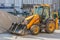 View of a loader tractor standing next to a pile of earth at the construction site