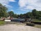 view of the lock gates at brighouse basin on the calder and hebble navigation canal with barges and canalside buildings