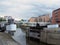 A view of the lock gates outside clarence dock in leeds with people on the island next to knights bridge and city apartment