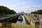 View on lock sluice at river Maas with cargo ship, blurred towers of RWE power station background