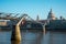 A view of London Millenium Bridge and St Paul`s Cathedral from Bankside in South Bank of Thames River