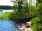 View of a lonely lake beach with green boat