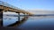 View Of Lonely Long bridge On Baltic Sea With Sandy Beach In Windy Day