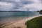 View of Long Beach seaside walk on a stormy spring day with dark moody sky and intense tones in the water