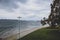 View of Long Beach seaside walk on a stormy spring day with dark moody sky and intense tones in the water