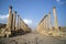 A view looking down the Cardo showing stone carved columns and paved street at the ancient city of Jarash or Gerasa, Jerash in