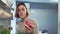 View Looking Out From Inside Of Refrigerator As Woman opens door takes an apple then puts it back and takes donut