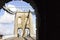 View looking out onto the Menai Suspension Bridge & A5 traffic route through an open-air stone archway, Gwynedd, North Wales