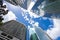 View looking up at blue cloudy sky through skyscrapers reflecting clouds and other buildings in CBD Brisbane Queensland Australia