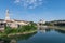 view looking up the Fiume Adige towards the St Giorgio church in Verona Italy