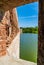 View from the loophole of the old fort to the old brick wall and moat, filled with water around the walls of the fort