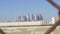 View of Los Angeles downtown skyline through chain link fence on blue sky summer day in slow motion