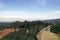 A view of Los Angeles panorama and an asphalt road in a park in California