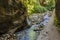 A view of the the Los Cahorros walk and the Monachil river as it exits a tunnel in the Sierra Nevada mountains, Spain