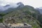 View of the Lost Incan City of Machu Picchu near Cusco. Low clouds cover mountains. Cusco Region, Sacred Valley, Peru