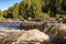 View from a low point on mountain waters seething on the rapids of a swift mountain river