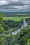 View of the Lucala river, with tropical plains and dramatic sky as background