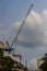 View of luffing jib tower crane at condominium construction site