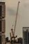 View of luffing jib tower crane at condominium construction site