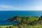 A view of the Lulworth Cove along the Jurrassic Coast in Dorset under a majestic blue sky and some white clouds