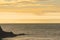 View of Lundy Island from the beach across the ocean