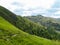 A view on lush green slopes of Austrian Alps in the region of Millstatt. There is a narrow pathway along the slope