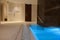 View of a luxurious modern interior design of a wellness spa center with a thermal swimming pool with underwater lights and