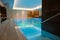 View of a luxurious modern interior design of a wellness spa resort with a thermal swimming pool with underwater lights and