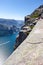 View at Lysefjord and steep Preikestolen cliff on Kjerag mountain. Passenger vessel floats from Lysebotn village. People hike to P