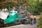 View of machinery and workers laying new bitumen on a suburban road near Hobart