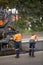 View of machinery and workers laying new bitumen on a suburban road near Hobart