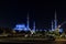 View of the magnificent The Sheikh Zayed Grand Mosque with beautiful blue light in the evening and nearest parking