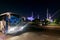 View of the magnificent The Sheikh Zayed Grand Mosque with beautiful blue lights in the evening and the bus waiting for tourists i